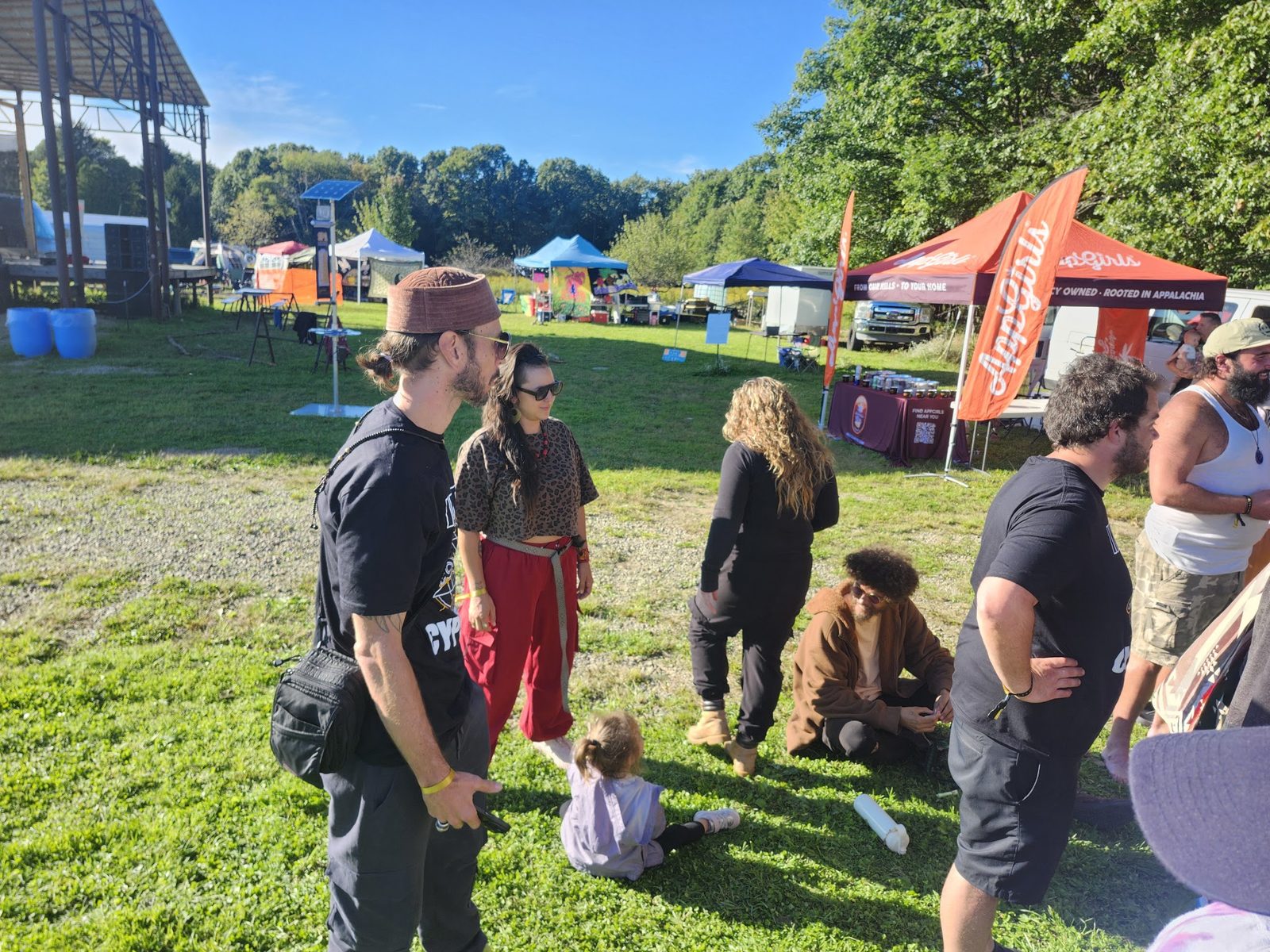 The festival grounds in daylight, vendor tents along the field