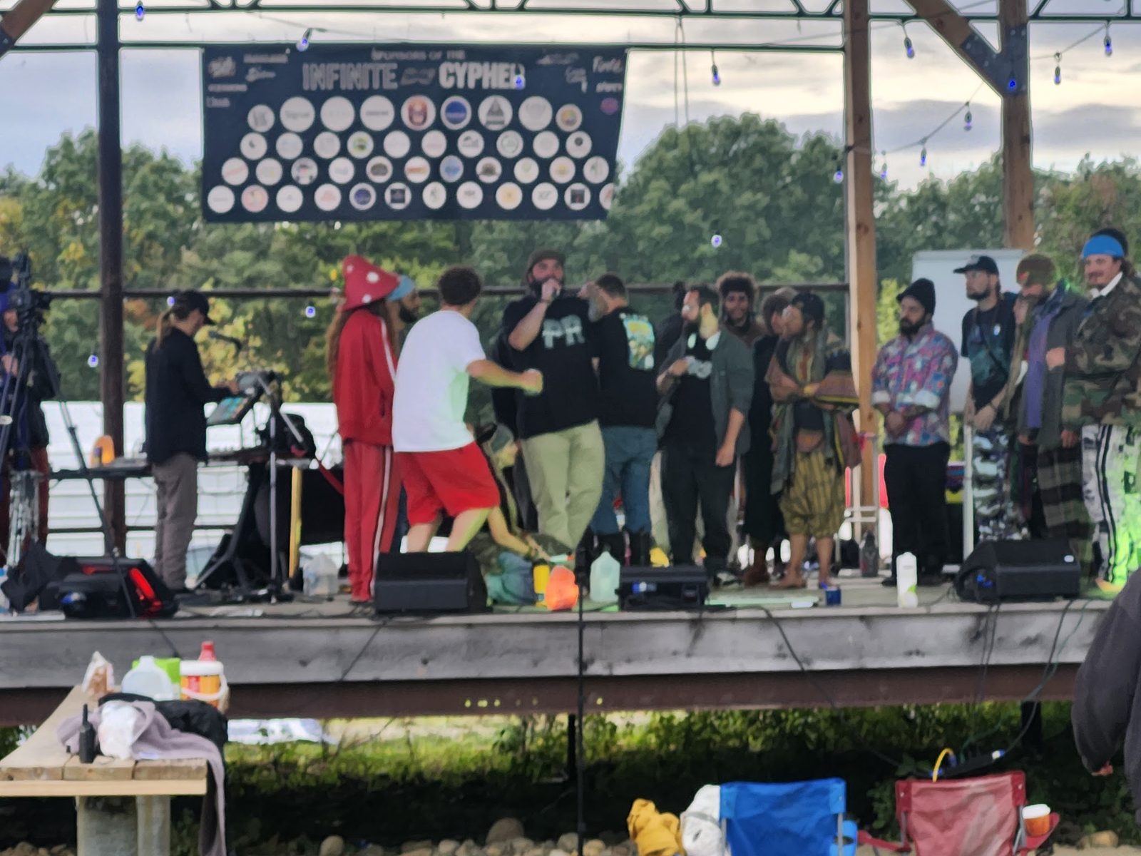 The stage from the field, artists gathered under the lineup banner